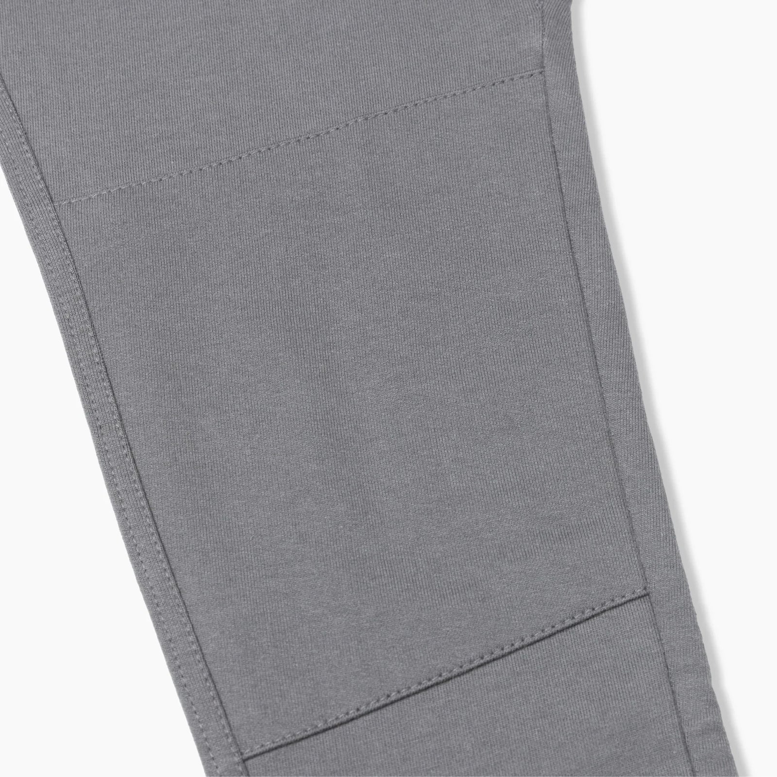 Detail of gray sustainable kids pants with reinforced knee, Jackalo clothing