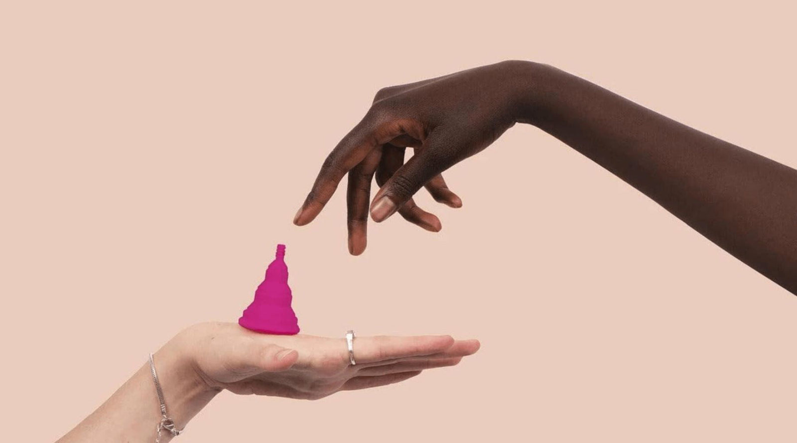Two hands with a pink silicone cup on a palm, sustainable kids brand Jackalo style