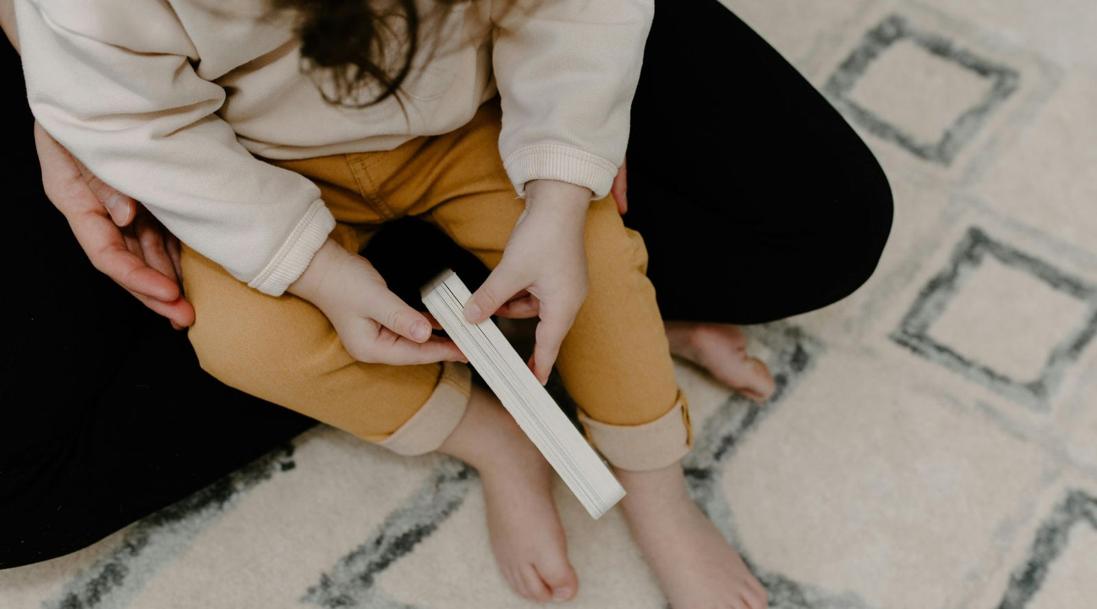 a kid playing and sitting on the floor