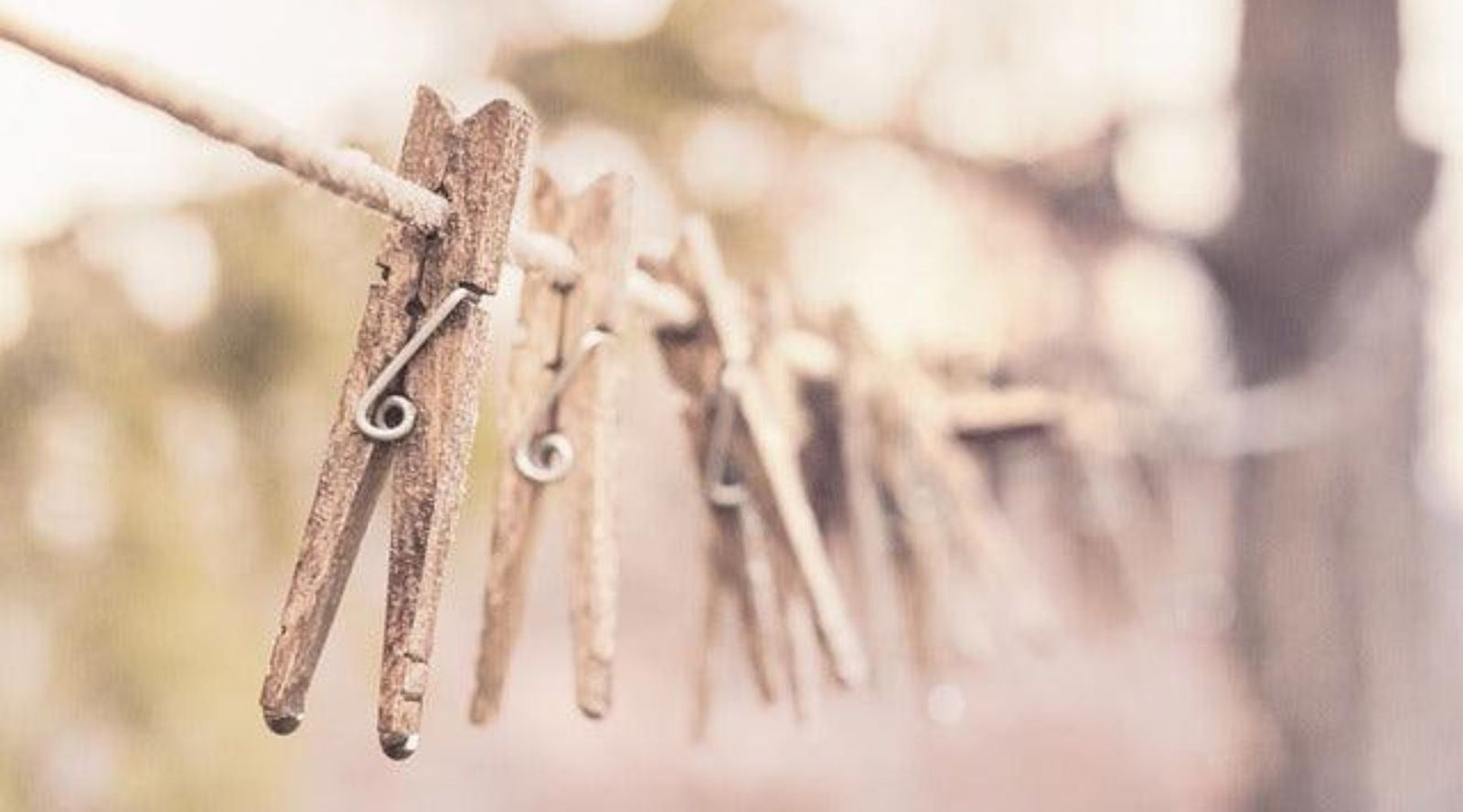a row of clothespin hanging on a clothesline