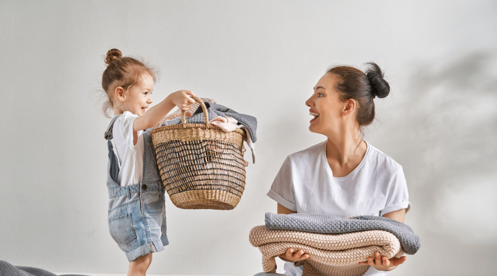 mom and daughter doing laundry