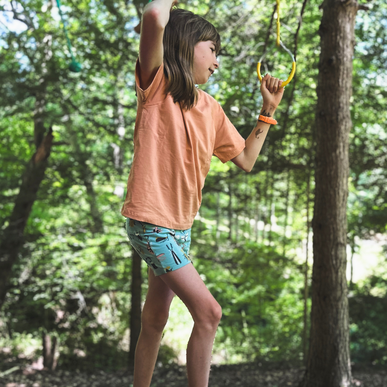 Jackalo kids' shorts with beetle mania insect print, aqua background, sustainable clothing
