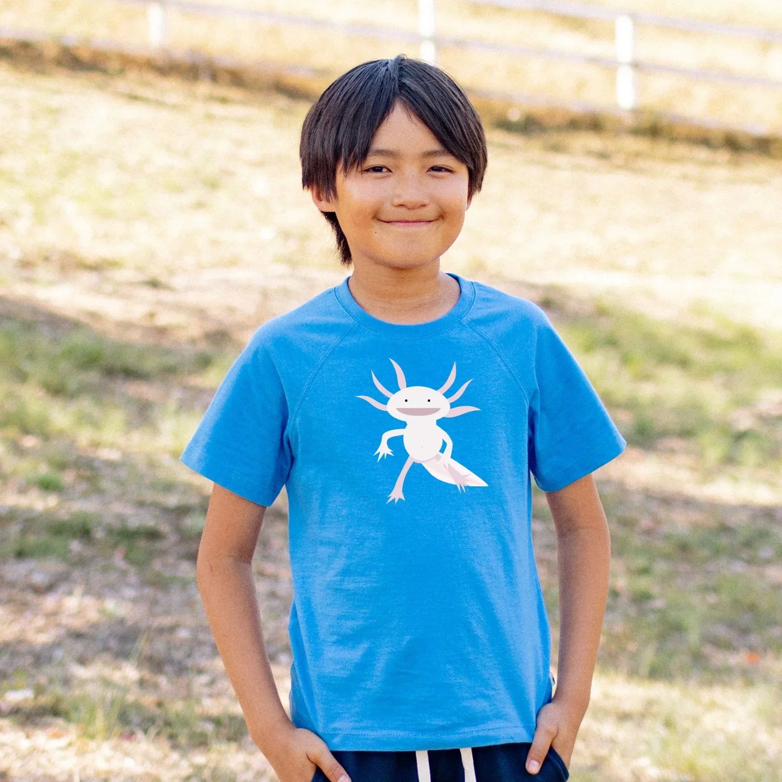 Blue t-shirt with a pale pink axolotl graphic