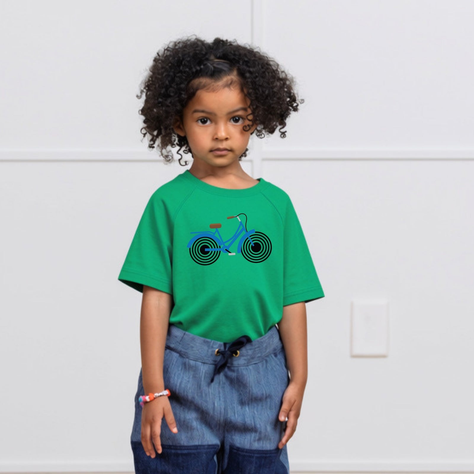Girl in green t-shirt with Bike print on it. Organic cotton t-shirt from Jackalo.