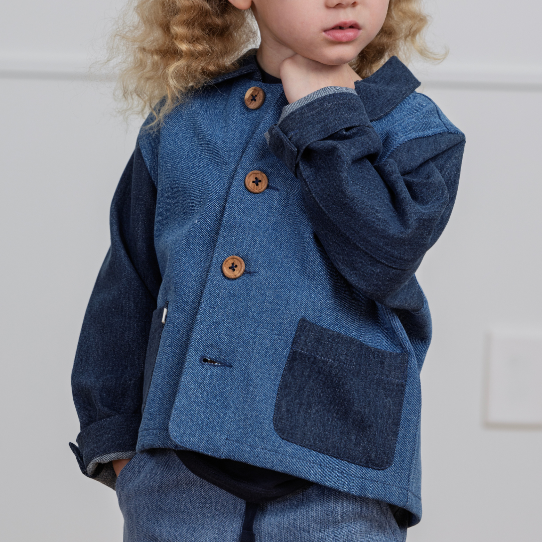 Child in durable denim jacket with wooden buttons and patch pocket, perfect for active play