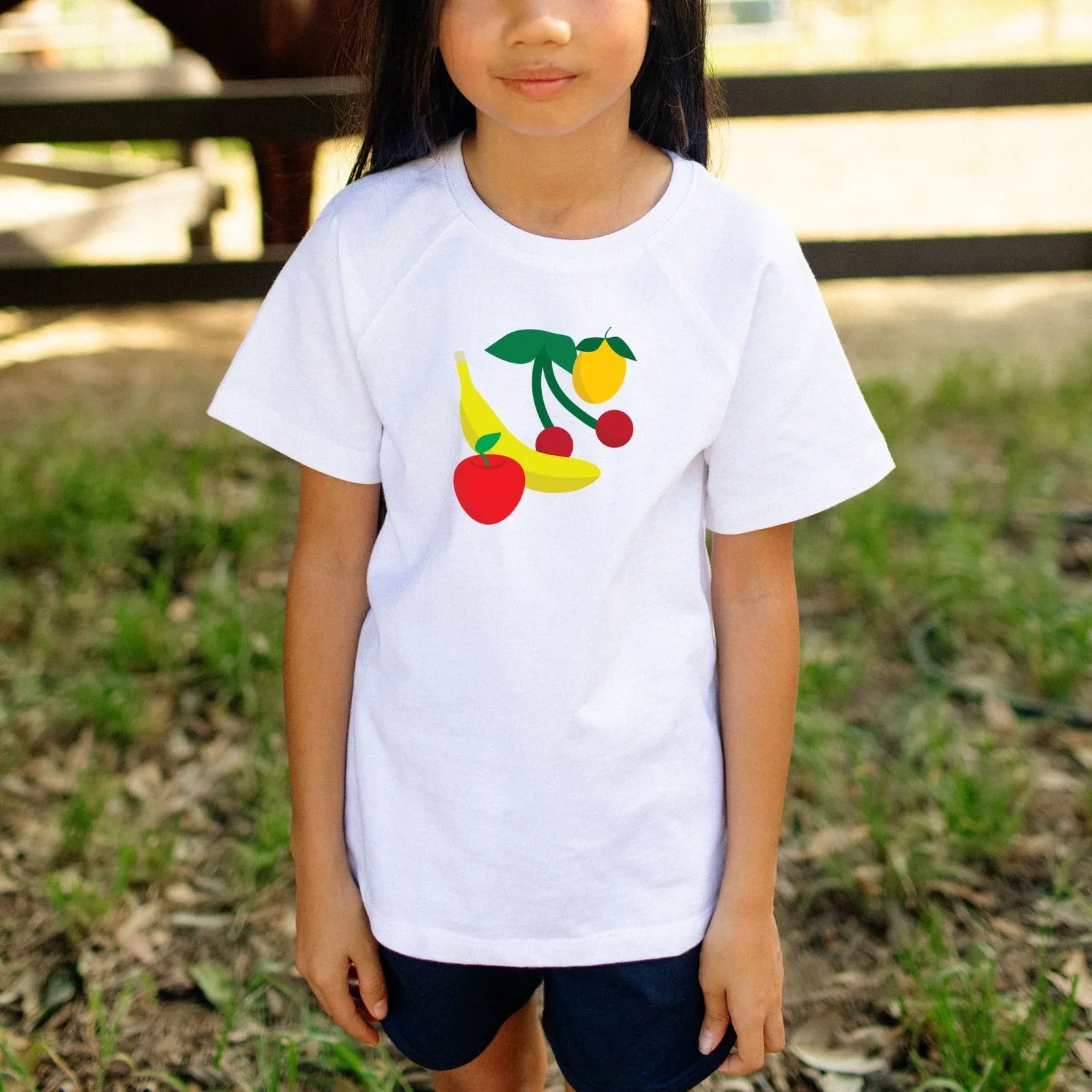 Kids white tee with colorful fruit print, perfect for active play outdoors