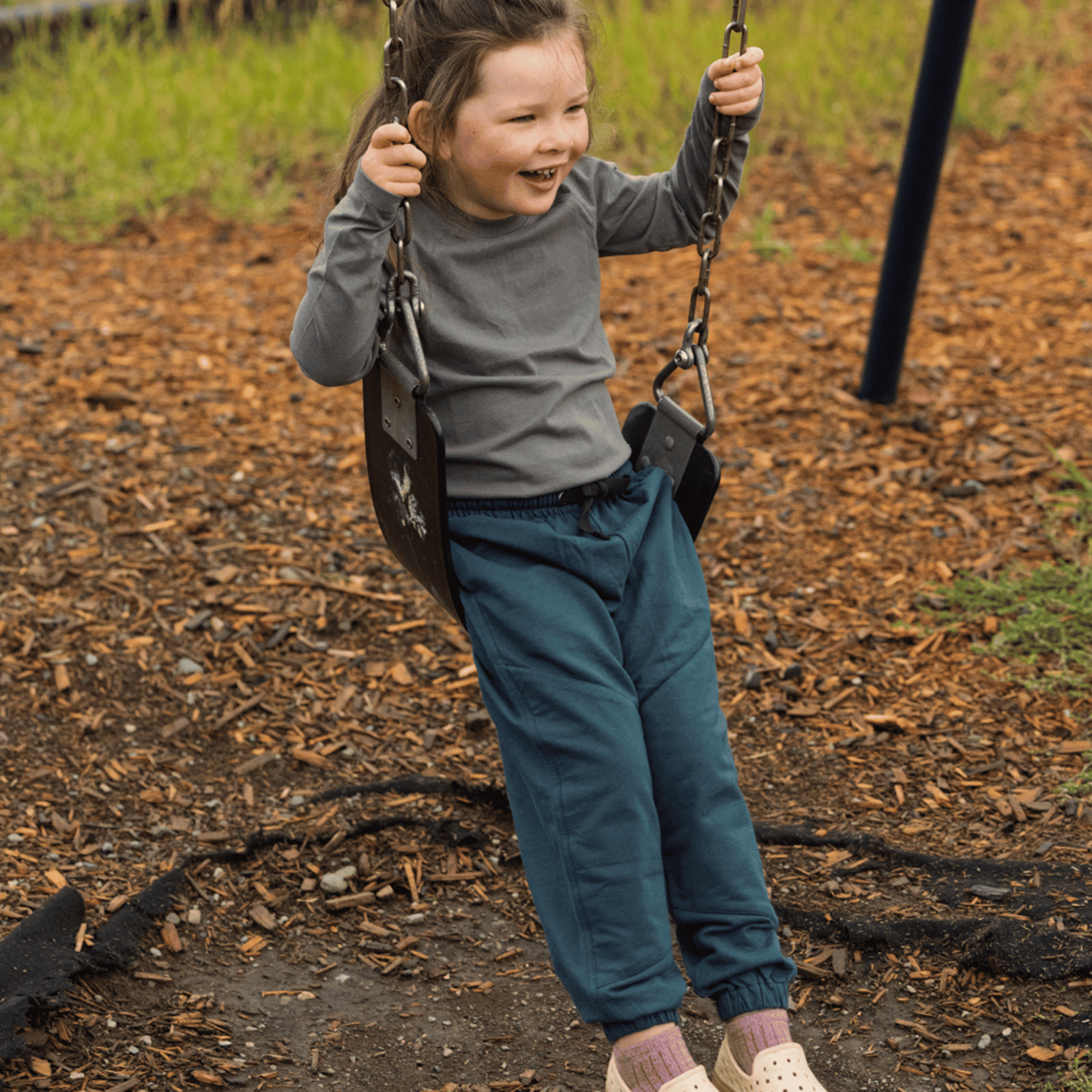 Dark green jogger pants with an elastic waistband, black drawstring, and elastic cuffs, shown flat on a white background.
