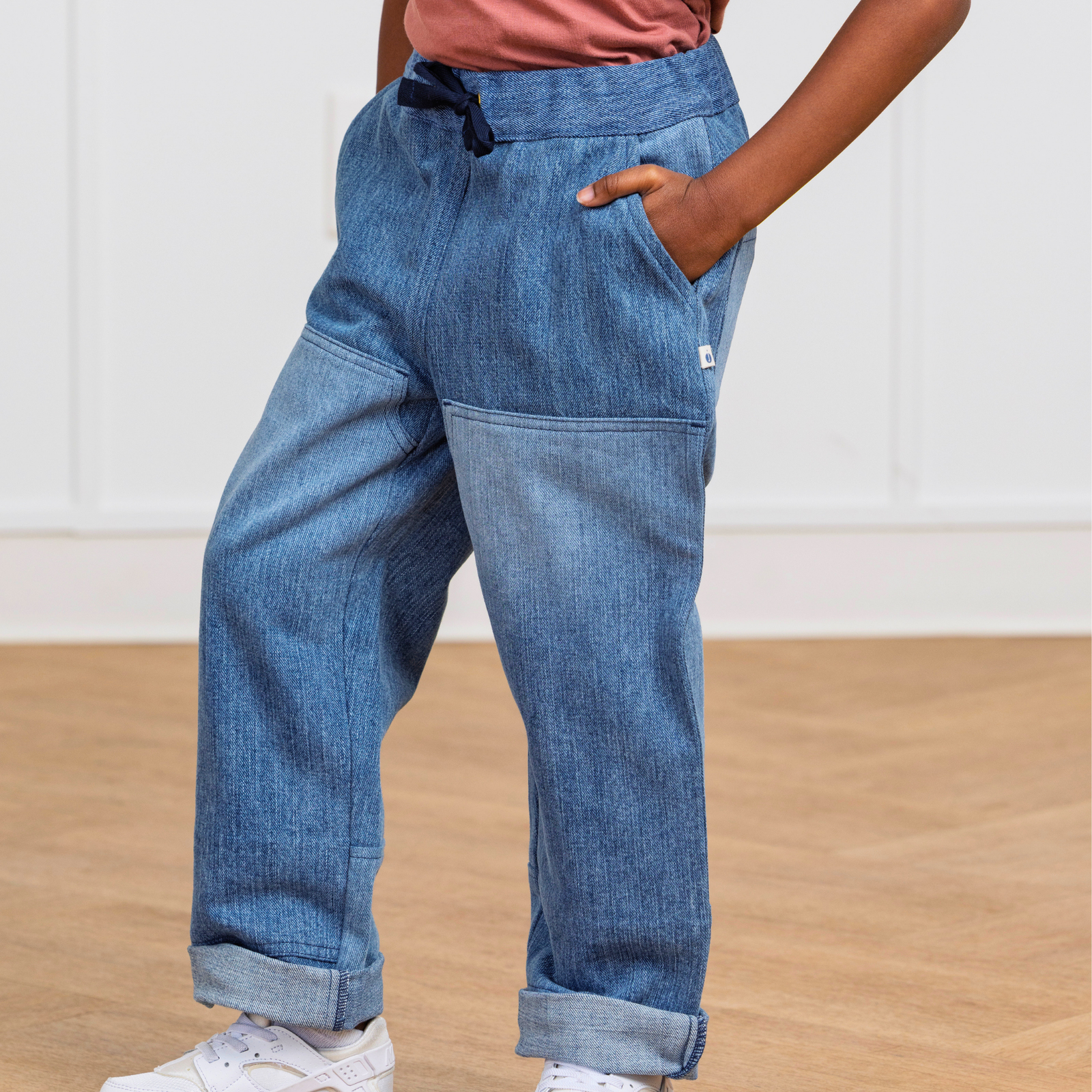 Kids' blue upcycled denim pants with drawstring waist, side pockets, and cuffed hems for active play