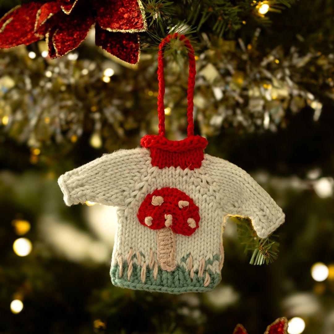 A mushroom knitted sweater ornament 