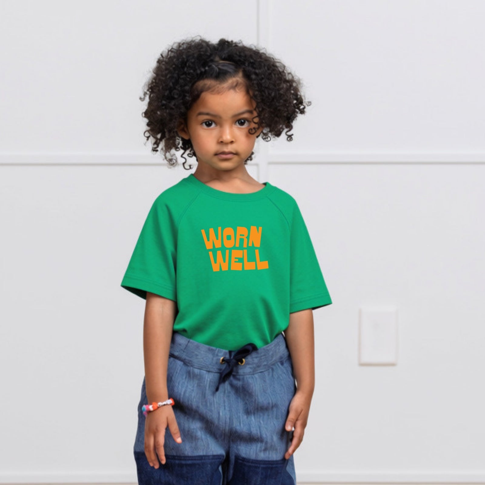 Green t-shirt with 'Worn Well' text on a white background