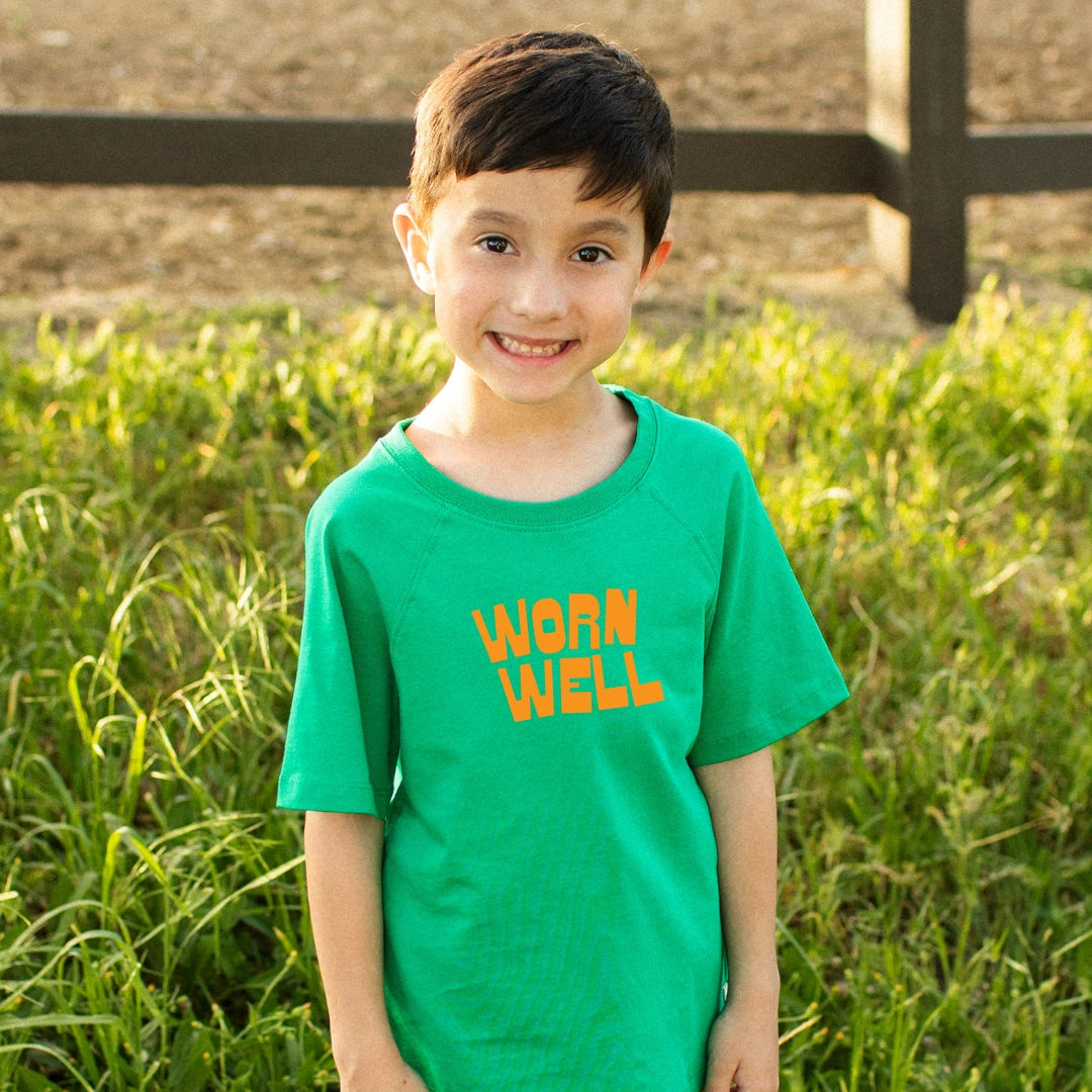 Green t-shirt with "worn well" graphic