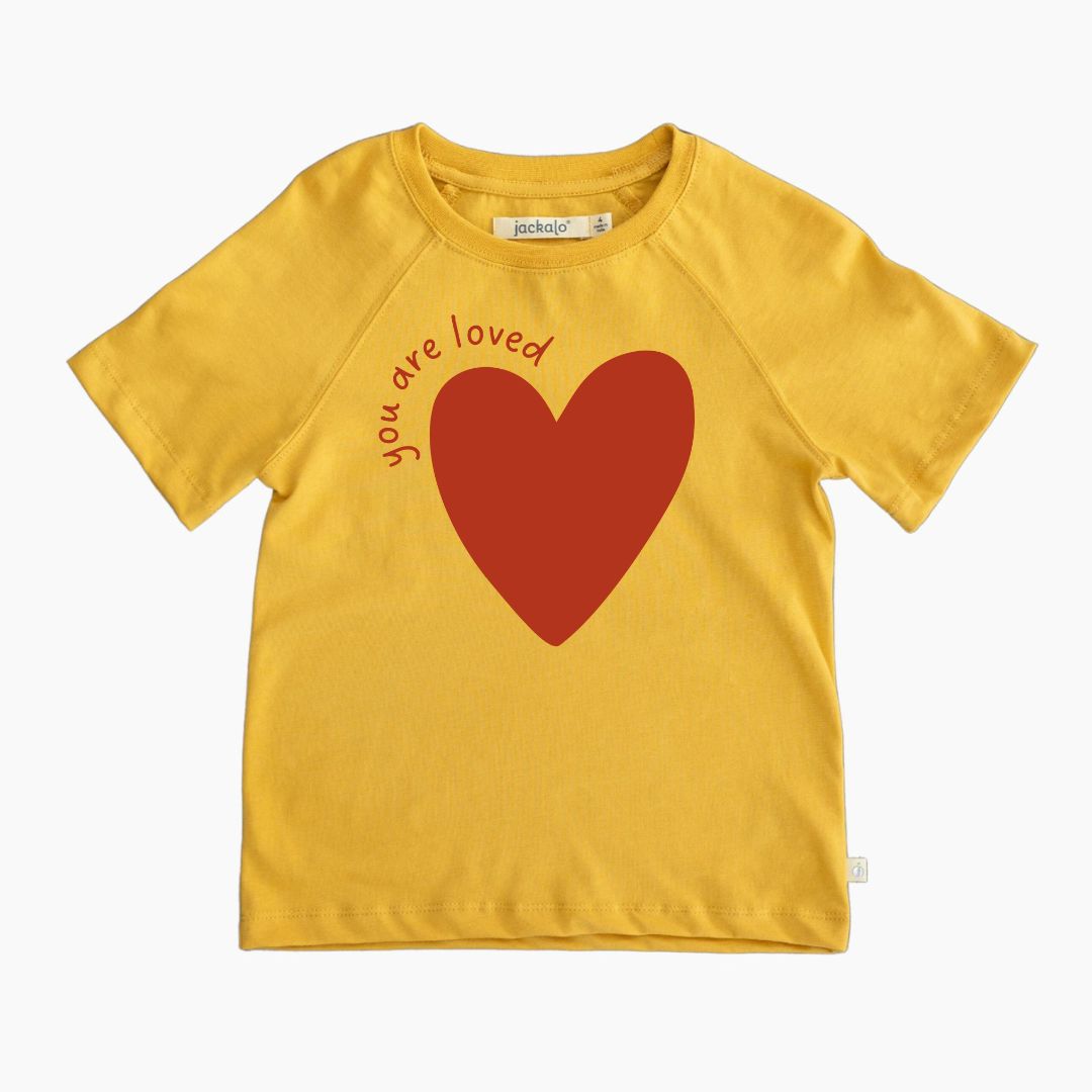 Organic yellow t-shirt with a red heart and 'you are loved' text on a white background