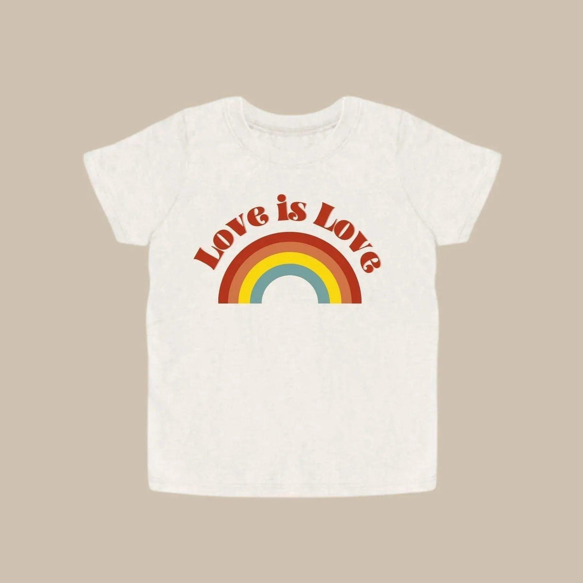 White shirt with &quot;Love is Love&quot; design in a light brown background