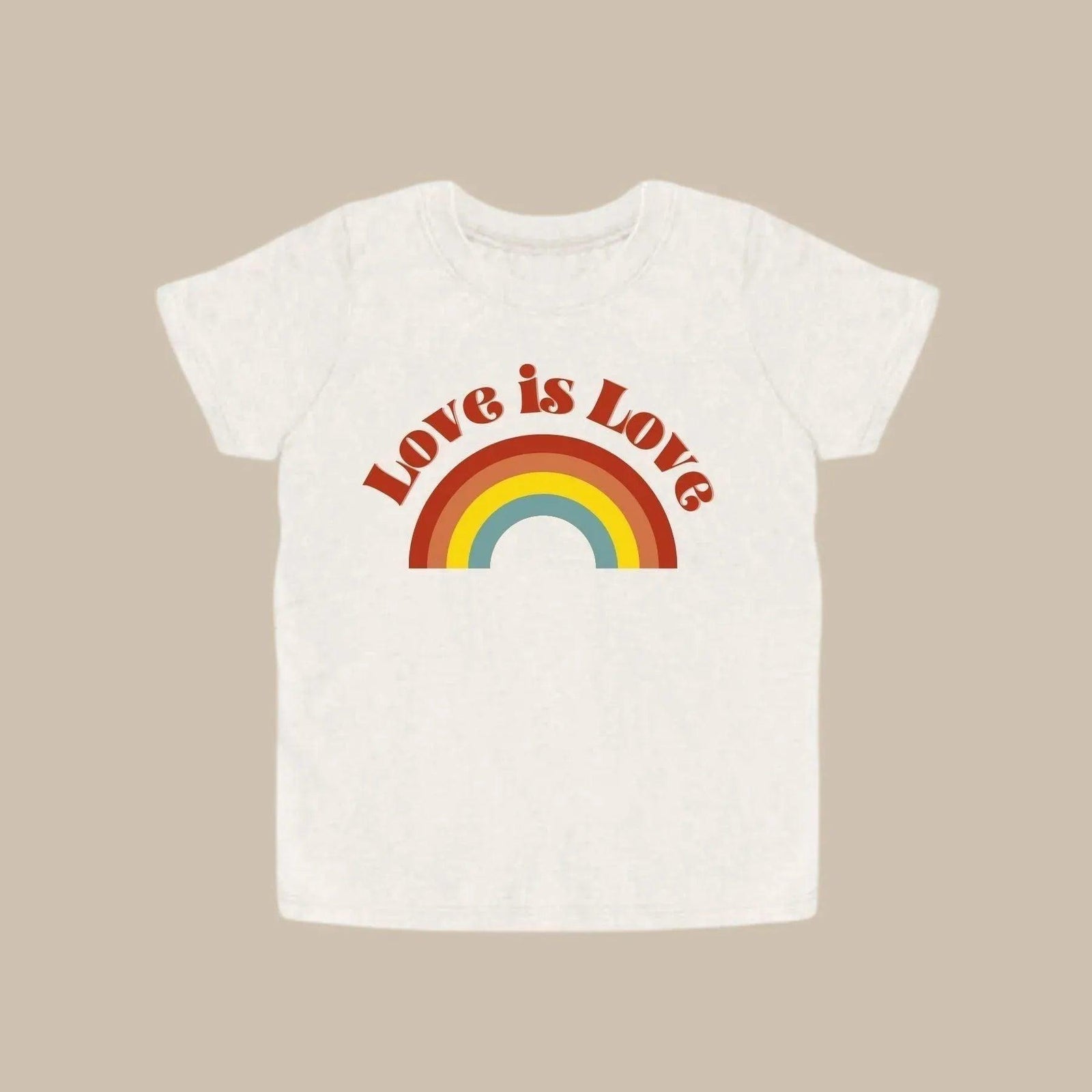 White shirt with "Love is Love" design in a light brown background